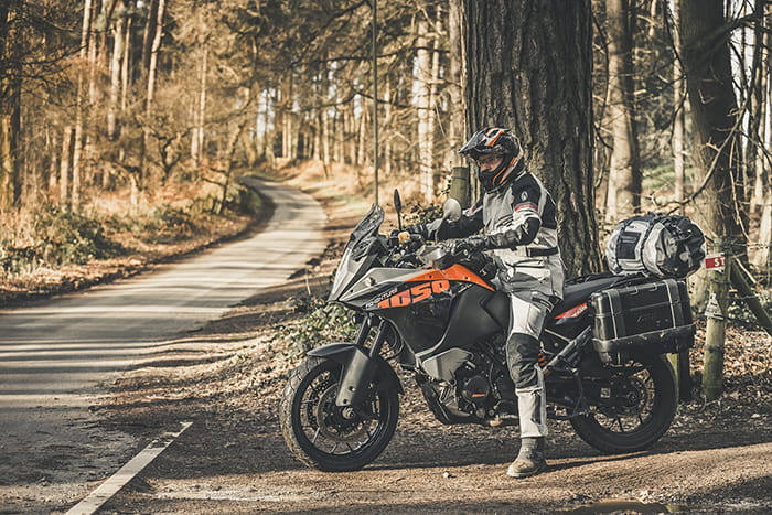 blue motorbike at the edge of a gravel road on a motorcycle touring trip