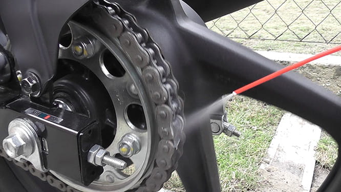 Lubricant being applied to a motorcycle chain