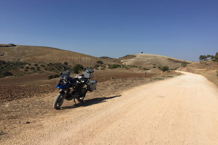 motorbike next to a tent at a campsite on a motorcycle touring trip